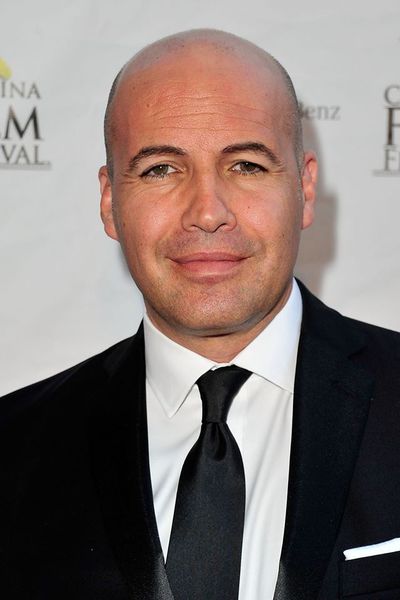 Portrait of a man in a black suit and tie at the Catalina Film Festival step-and-repeat backdrop.
