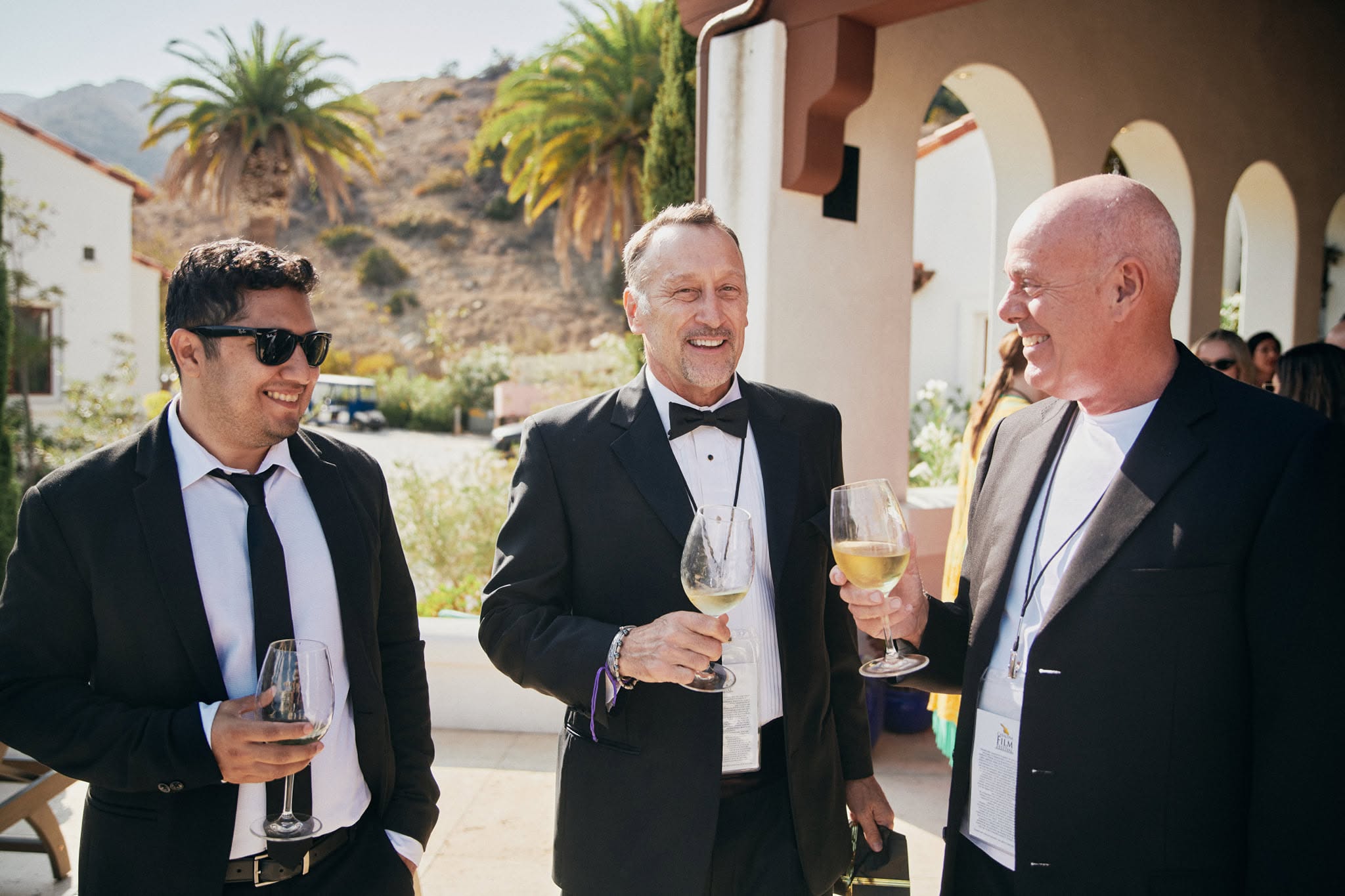 Festival guests wearing suits and tuxedo attire